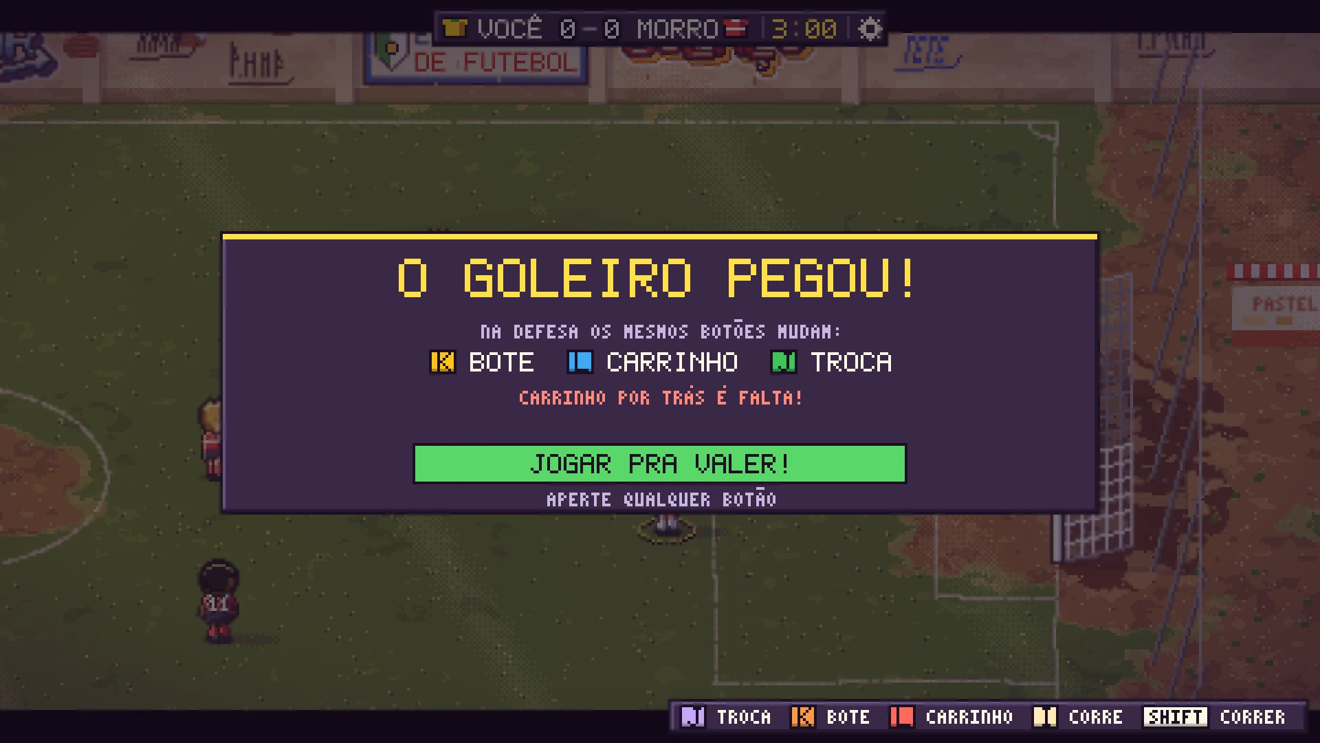 Tela do tutorial do Barrio Kick com o título O goleiro pegou e a explicação dos botões de defesa: K bote, L carrinho, J troca, e o aviso de que carrinho por trás é falta.