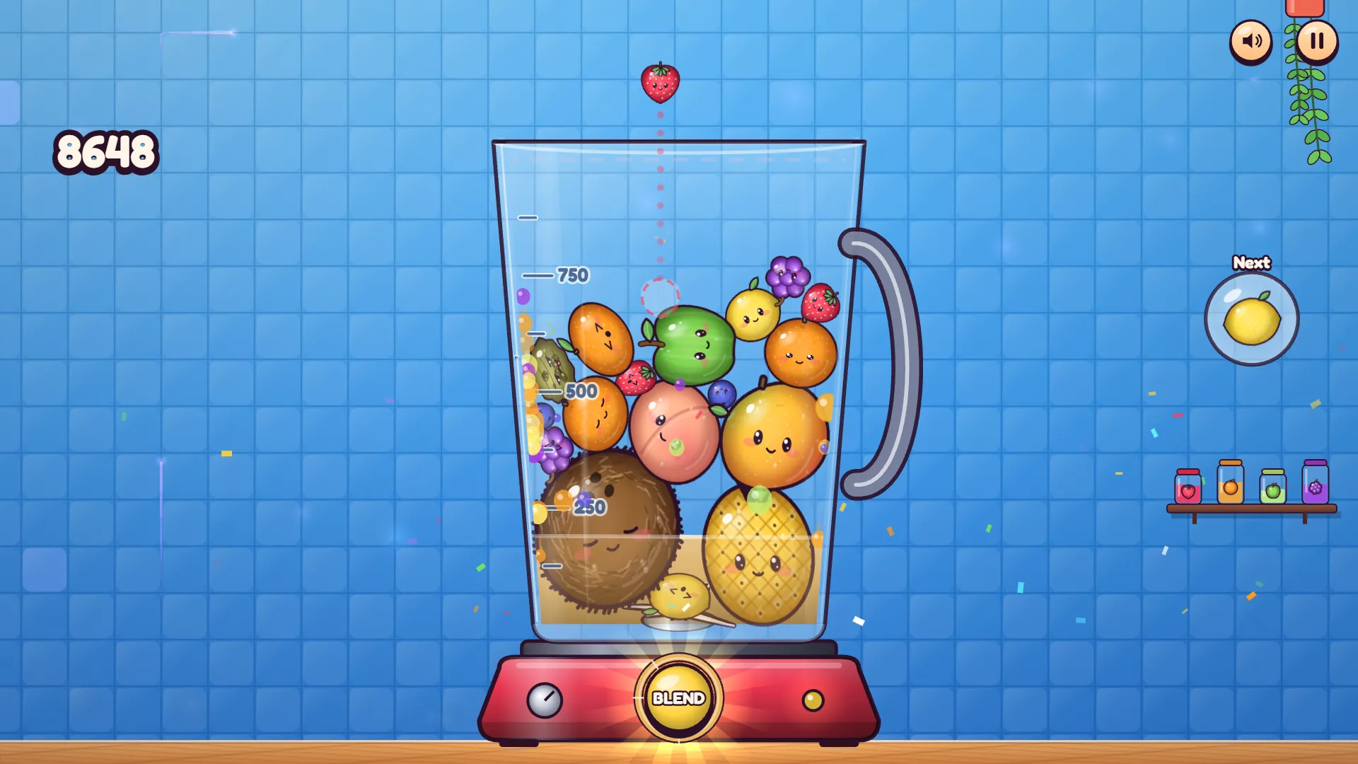 Nearly full Plop! blender with a coconut in the left corner, a pineapple on the right and the BLEND button lit
