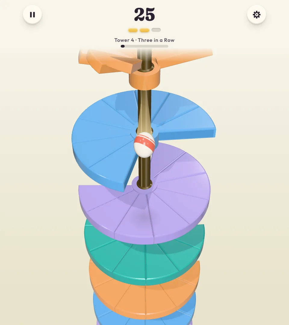 Twirldrop Tower 4, Three in a Row: score 25 and two of the three pills under the score lit in yellow, with the ball falling toward a lavender floor